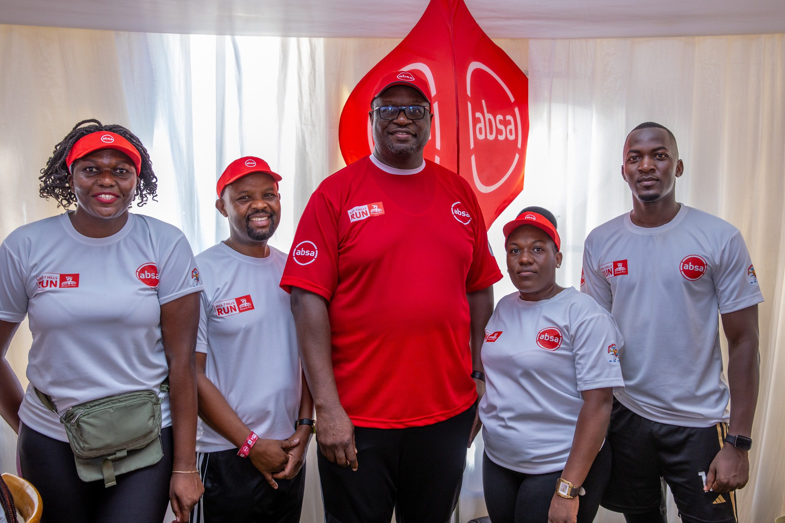 The Multilines team proudly poses alongside Mumba Keneth Kalifungwa, Absa MD, after completing the Absa KH3 7 Hills Run.